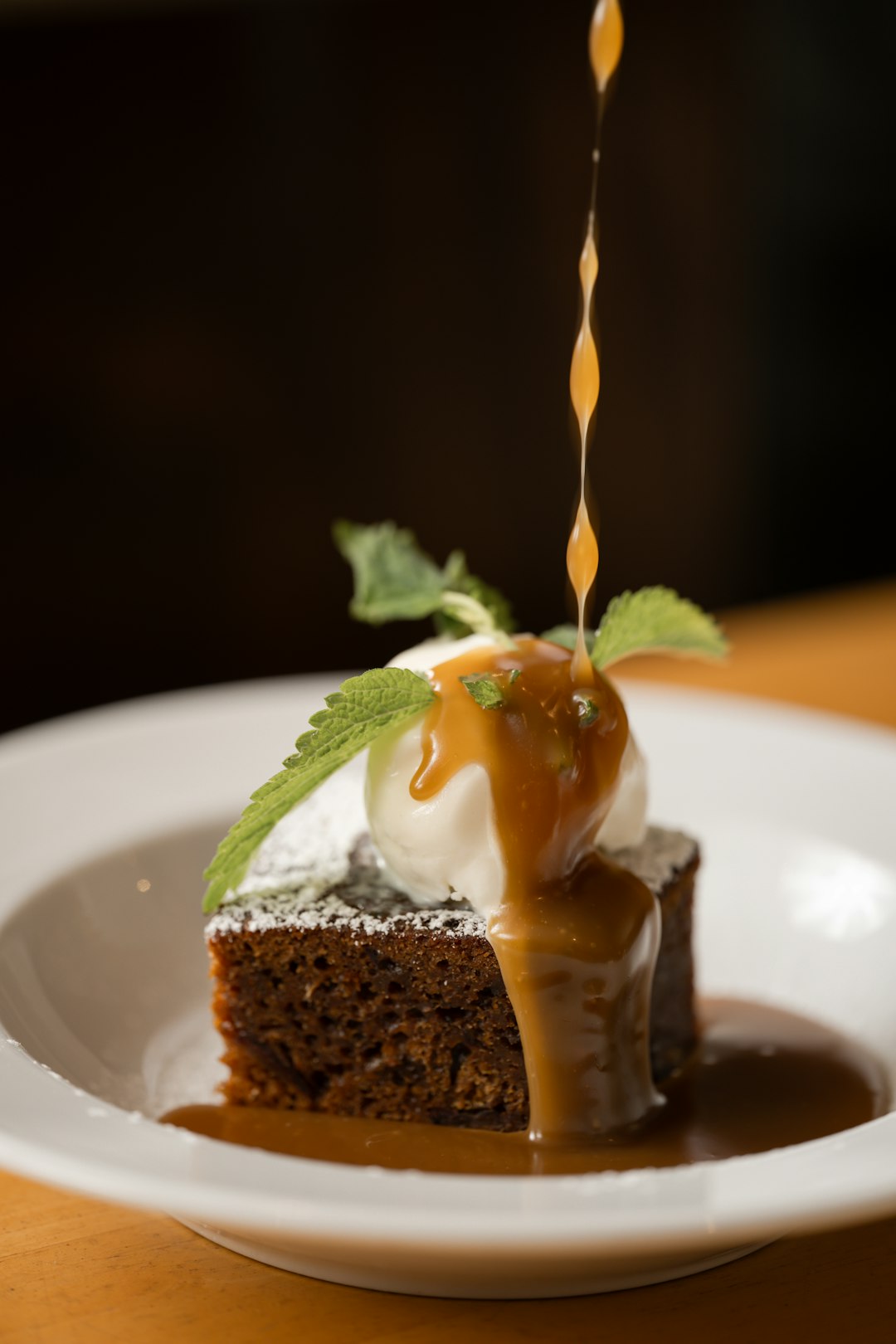 Warm date cake with caramel sauce and ice cream